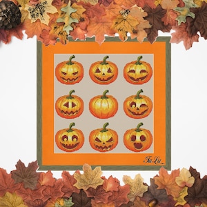 May include: A cross-stitch pattern featuring nine orange jack-o'-lantern pumpkins with different facial expressions. The pumpkins are arranged in a grid pattern on a beige background. The pattern is framed with a green and orange border. The text "Ta Liu" is in the bottom right corner.