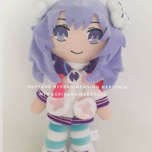 May include: A handmade plush doll of a character with lavender hair and eyes. The doll wears a white and purple outfit with striped blue and white leggings. Text on the doll reads "NEPTUNE HYPERDIMENSION NEPTUNIA NYONGKIHANDMADEDOLL".