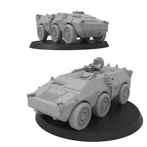 May include: Two gray plastic model military vehicles. The top vehicle is a troop transport with a machine gun on top. The bottom vehicle is a smaller armored car with a machine gun on top.