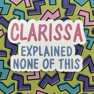 May include: A sticker with a pink background and white outline. The text on the sticker reads "Clarissa Explained None Of This".