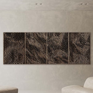 May include: A modern living room featuring a set of four abstract wooden wall panels with a black and beige wave pattern. Two curved beige sofas face each other, with a round stone coffee table in the center. The room has a neutral color palette.