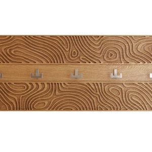 Oak wall 35x14 inch hanger. Wall mounted coat rack with brushed steel, inox hooks. Carved 3D modern furniture. Liquid Materia motif.
