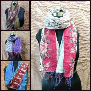 May include: Three different styles of kantha stitch scarves. The scarves are made of recycled saris and feature floral patterns. The scarves are displayed on mannequins. The text "Countdown Mart" is visible on two of the scarves.