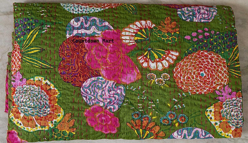 May include: A green floral quilt with a vibrant design. The quilt features large pink, orange, and white flower patterns, along with other colorful shapes. The text "Countdown Mart" is visible on the quilt.