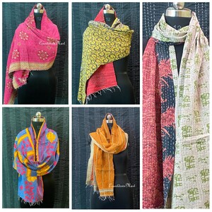 May include: Five different kantha quilts, each with a unique pattern and color combination. The quilts are made of recycled saris and are hand-stitched. The quilts are displayed on mannequins and are folded in a variety of ways. The quilts are all different sizes and shapes. The quilts are all made of cotton and are soft and comfortable. The quilts are perfect for adding a touch of color and style to any room.