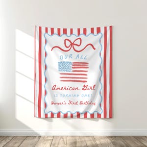 May include: A red and white striped tapestry with a white center featuring a red bow, an American flag, and the text "OUR ALL American Girl IS TURNING ONE! Harper's First Birthday."