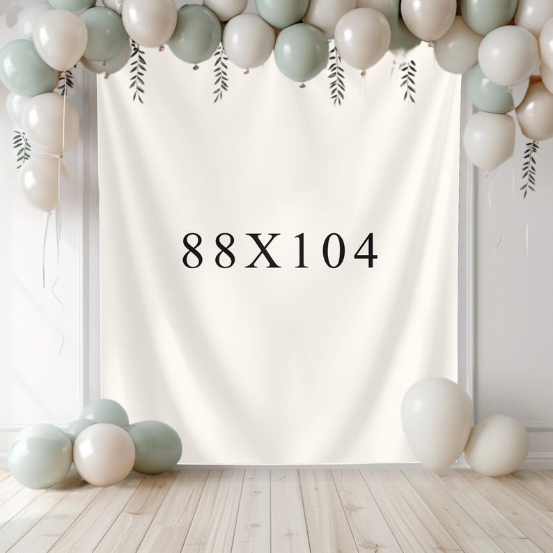 May include: A cream-colored backdrop with the text "88X104" in black, decorated with balloons in white and sage green. The balloons are arranged at the top and bottom of the backdrop, creating a festive atmosphere. The backdrop is likely used for events or photography.
