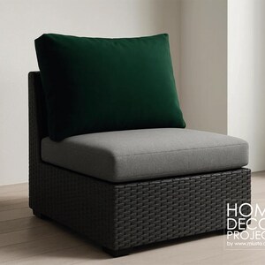 May include: A modern outdoor chair with a dark gray woven base, a light gray seat cushion, and a dark green back cushion. The chair is designed for outdoor use. The text "HOME DECOR PROJECTS" is visible on the right side.