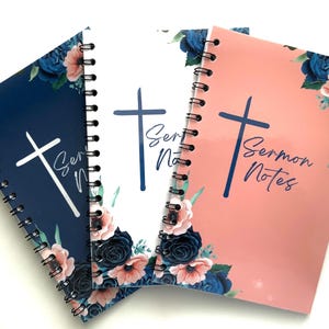 May include: Three spiral bound notebooks with floral designs. The notebooks are blue, white, and pink. Each notebook has a cross and the text "Sermon Notes" printed on the front.