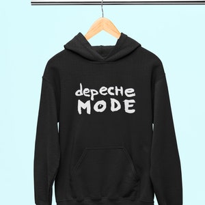 May include: Black hooded sweatshirt with a white graphic print of the text "Depeche Mode" on the front.