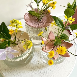 May include: A set of three ceramic mugs with a speckled, matte finish. The mugs are in shades of cream, light gray, and dark gray. Each mug has a simple, minimalist design, perfect for coffee or tea.