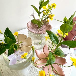 May include: A set of three ceramic mugs with a speckled, matte finish. The mugs are in shades of cream, light gray, and dark gray. Each mug has a simple, minimalist design, perfect for coffee or tea.