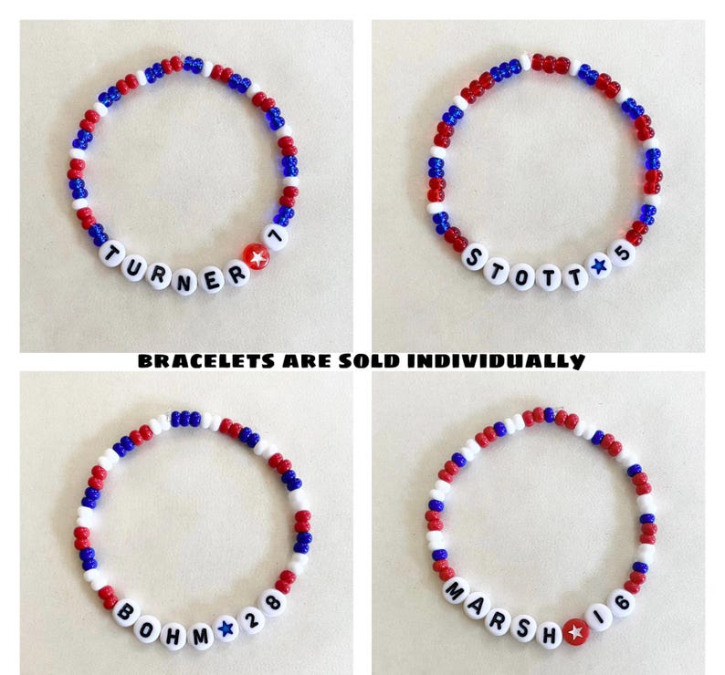 May include: Four beaded bracelets with red, white, and blue beads. Each bracelet has a name and number spelled out with white letter beads. The text "BRACELETS ARE SOLD INDIVIDUALLY" is at the bottom of the image.