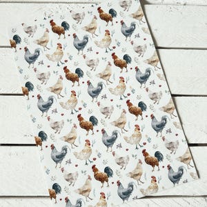 May include: A white fabric with a repeating pattern of watercolor roosters and hens. The roosters are brown, red, and gray, and the hens are white and gray. The background is white with small green leaves and red berries.