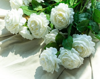 A white artificial rose with a genuine touch  Roses at the wedding