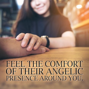 May include: Image of two hands clasped on a wooden table. The text reads: "FEEL THE COMFORT OF THEIR ANGELIC PRESENCE AROUND YOU." A person is in the background, out of focus.
