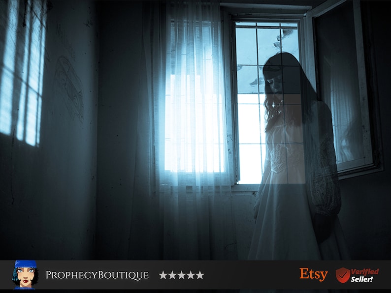 May include: A woman in a white dress stands by a window in a dimly lit room. The window is covered with a sheer curtain and the light from outside casts shadows on the wall.
