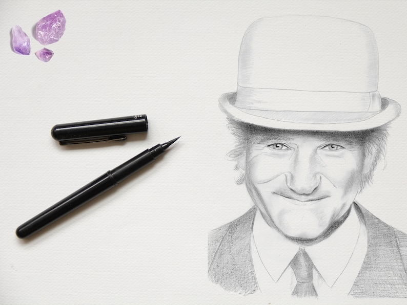 May include: A black and white pencil drawing of a man wearing a hat and a suit. The man is smiling and has a kind expression on his face.