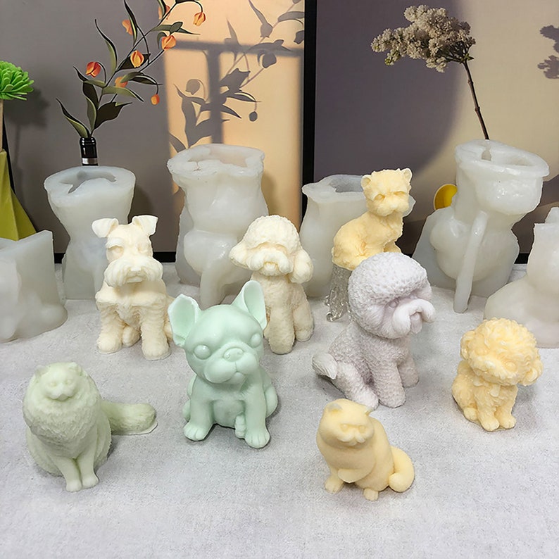 May include: A collection of white and pastel colored dog and cat figurines. The figurines are made of a smooth, glossy material and are arranged on a white surface.