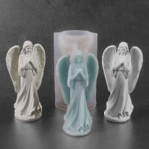May include: Three angel figurines, two in white and one in light blue, with wings and hands clasped in prayer. The figurines are displayed next to a silicone mold.