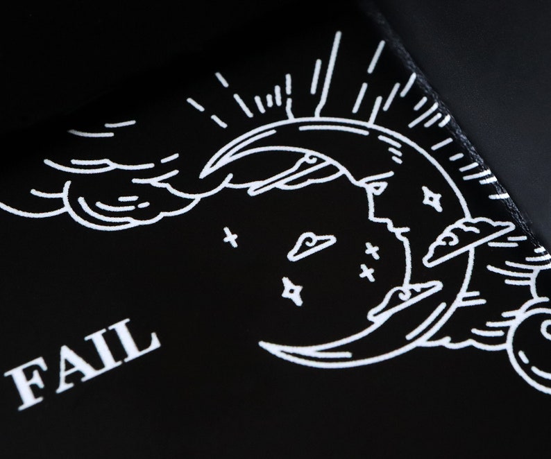 May include: Black tray with a white crescent moon design, clouds, and stars. The word "FAIL" is printed in white on the tray.