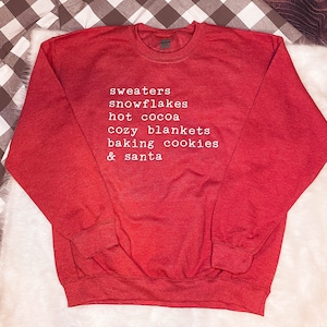 Sweaters, Snowflakes, Hot cocoa, Cozy Blankets, Baking Cookies and Santa Sweatshirt
