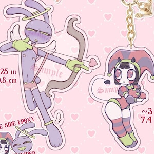 May include: Preorder Funnybunny acrylic charms. The image shows two charms, one is a purple bunny with a bow and arrow, the other is a jester bunny. The charms are double-sided epoxy and measure approximately 4.25 inches (10.8 cm) and 3 inches (7.4 cm) in height.