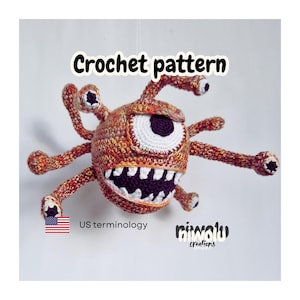 Peut inclure: Un monstre crocheté avec plusieurs yeux et tentacules. La créature est principalement orange et marron, avec un grand œil blanc et noir. La bouche présente des dents blanches et un intérieur violet. Le texte "Crochet pattern" est affiché au-dessus du monstre.