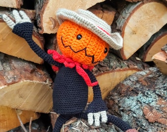 Crochet pattern - Halloween pumpkin man with straw hat and lanky black arms and legs.