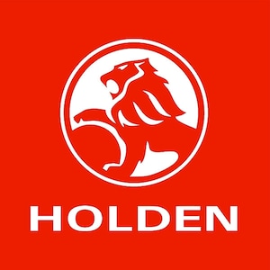 May include: A white lion logo with a red background. The lion is inside a white circle with a white outline. The word "HOLDEN" is written in white letters below the logo.
