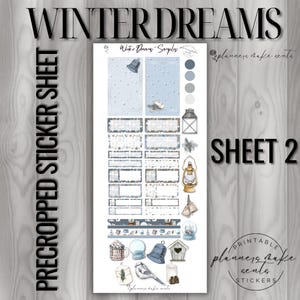 May include: A pre-cropped sticker sheet with a winter theme. The sheet features various stickers with illustrations of bells, lanterns, snow globes, and a blue jay. The text "WINTER DREAMS" and "SHEET 2" are visible.