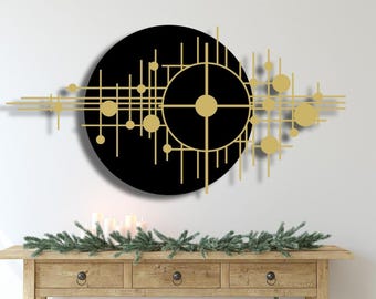 May include: A black and gold geometric wall art piece with a circular design. The art features a large circle with a smaller circle inside, both with a grid pattern. The design is accented with smaller circles and lines.
