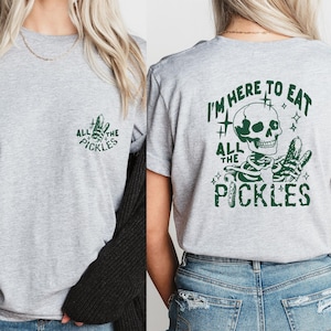 May include: Gray t-shirt with a skeleton graphic and the text "I'm here to eat all the pickles".