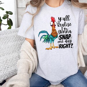 May include: A gray t-shirt with a cartoon rooster and the text "y'all realize I'm gonna snap one day right?"