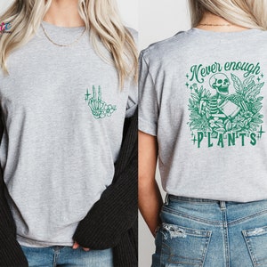 May include: Gray t-shirt with a green skeleton graphic holding a plant and the text "Never enough plants".