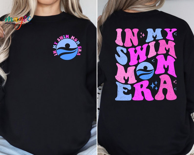 May include: Black sweatshirt with a pink and blue graphic that says "In My Swim Mom Era" on the back and a smaller version of the graphic on the front.