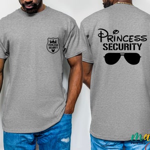 May include: Gray t-shirt with a black graphic of a crown and the text "Princess Security". The graphic also includes a pair of sunglasses.