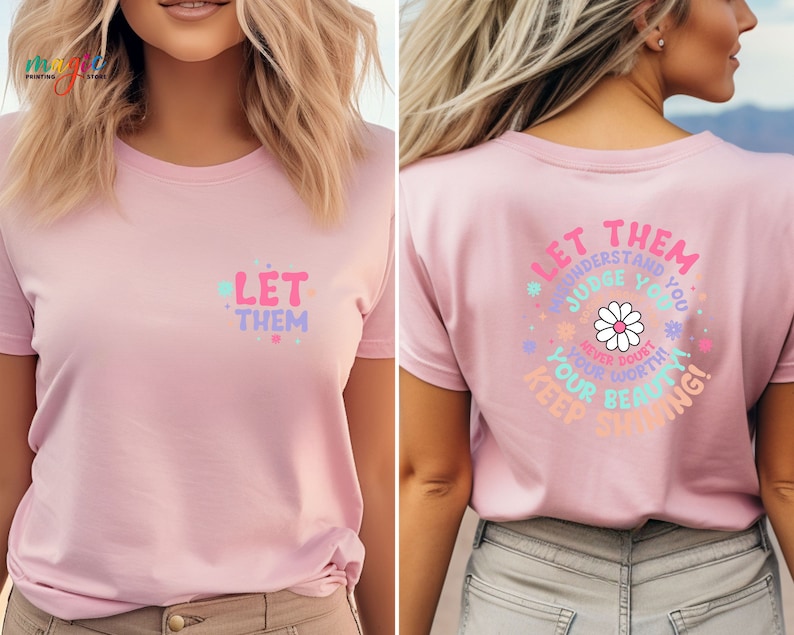 May include: Pink t-shirt with the text "Let them understand, judge you, never doubt your worth, keep shining!" in a colorful, daisy-themed design.
