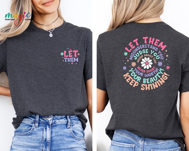 May include: A dark gray t-shirt with a pink and blue graphic print on the back that says "Let them misunderstand you, judge you, gossip about you. Never doubt your worth. Keep your beauty shining!" and a smaller print on the front that says "Let them".