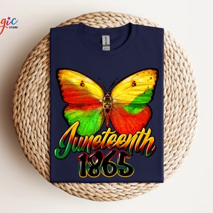 May include: A navy blue t-shirt with a colorful butterfly graphic and the text "Juneteenth 1865".