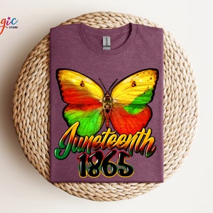 May include: A purple t-shirt with a colorful butterfly graphic and the text "Juneteenth 1865".