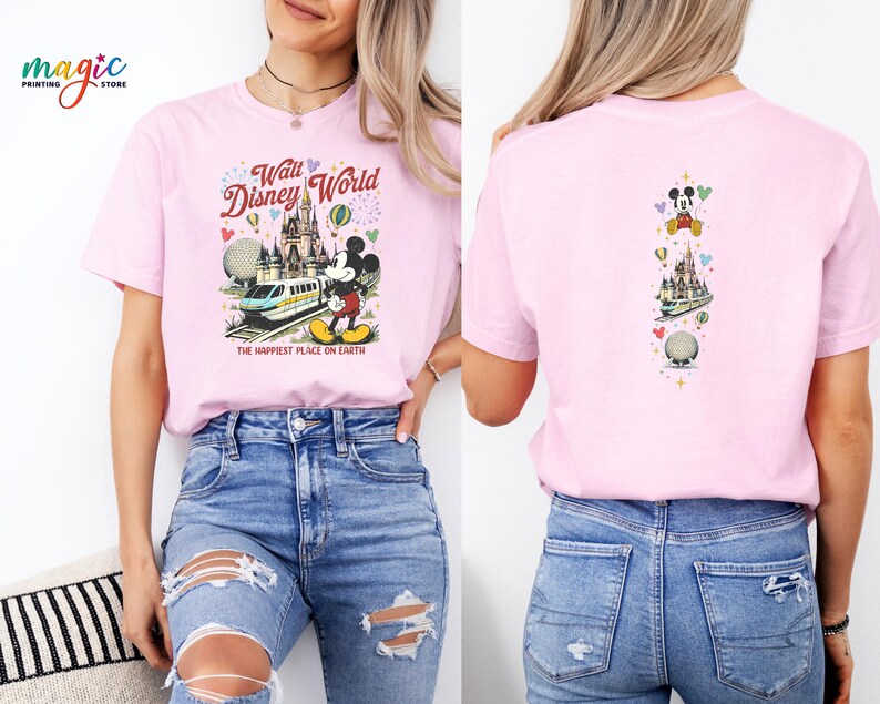 May include: Pale pink t-shirt with a Walt Disney World graphic. The front shows Mickey Mouse, a monorail, and Cinderella's castle, with the text "Walt Disney World" and "The Happiest Place on Earth". The back has a vertical design with Mickey Mouse and other Disney icons.