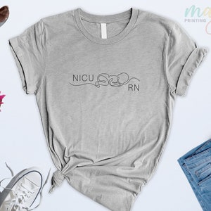 May include: A gray t-shirt with the text "NICU RN" and a line drawing of a baby.