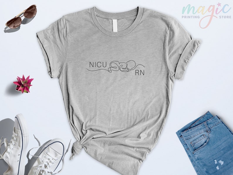 May include: A gray t-shirt with the text "NICU RN" and a line drawing of a baby.