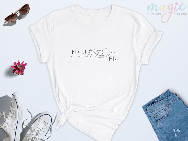 May include: White t-shirt with a black line drawing of a baby and the text "NICU RN".