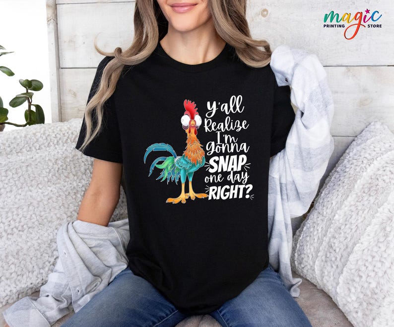 May include: A black t-shirt with a colorful rooster illustration and the text "y'all realize I'm gonna snap one day right?"