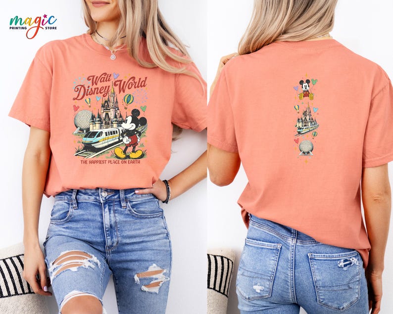 May include: Coral t-shirt with a Walt Disney World design on the front and back. The front features a castle, train, Mickey Mouse, and the text "Walt Disney World" and "The Happiest Place on Earth." The back has a vertical design with Mickey Mouse, a castle, and a globe.