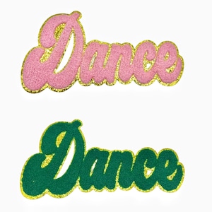 May include: Two iron-on patches with the word "Dance" in a retro, cursive font. The top patch is pink with gold glitter trim. The bottom patch is green with gold glitter trim.