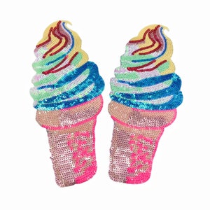 May include: Two colorful ice cream cone shaped patches with sequins. The ice cream is a swirl of pink, blue, green, and yellow. The cone is pink.