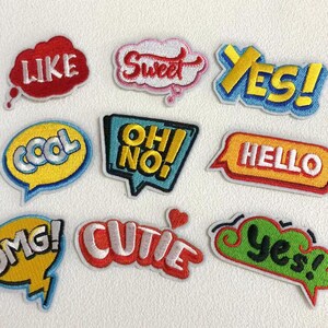 May include: Ten colorful embroidered iron-on patches with various phrases, including "Like", "Sweet", "Yes", "Cool", "Oh No", "Hello", "OMG", "Cutie", and "Yes".